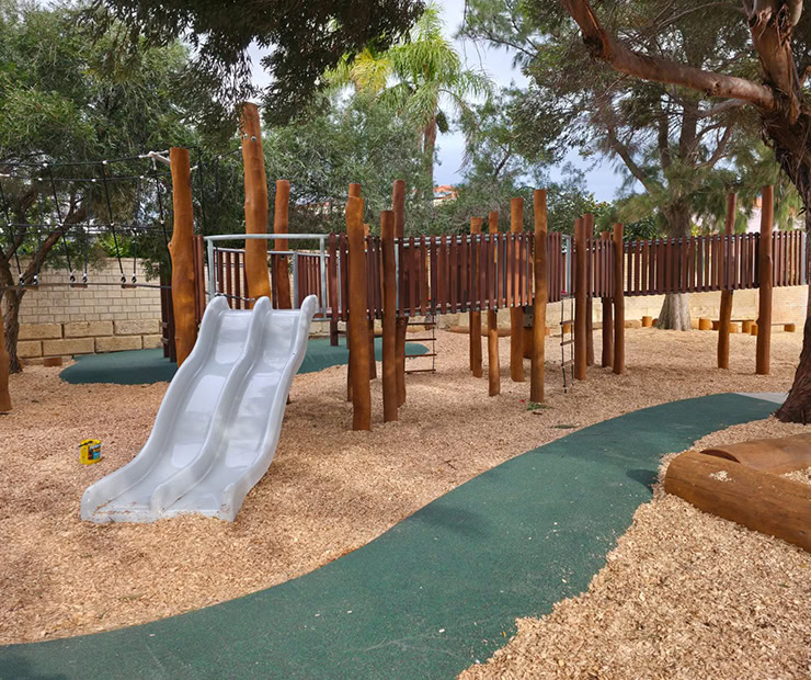 Climbing playground with slide and wooden structures at DG Play park.