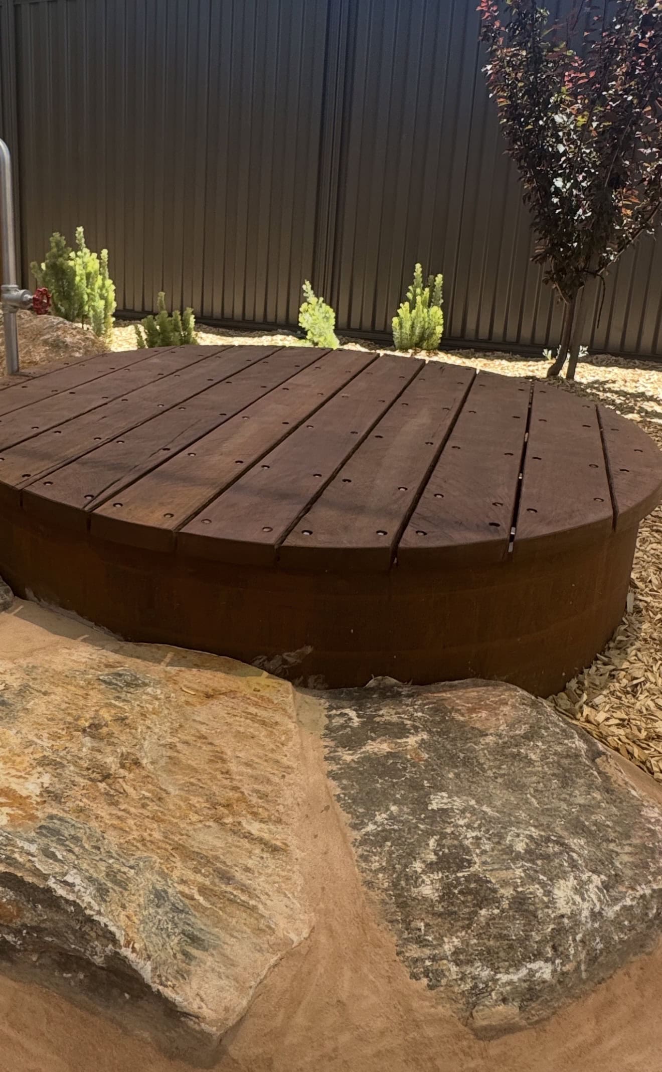 Outdoor platform pod made of durable wood, designed for comfortable seating and social gatherings in backyard or garden settings.
