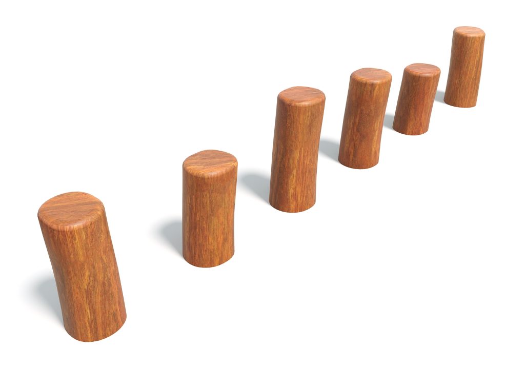 Six wooden cylinders arranged in ascending order from left to right, casting shadows on a white background.
